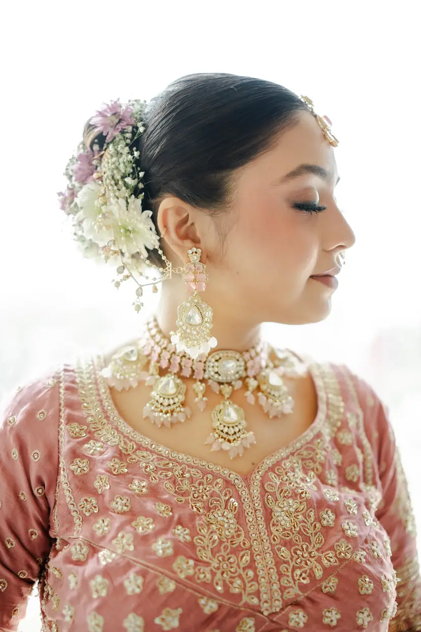 A bride in bridal jewellery, eyes closed